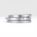 Órbita collection — three 2mm sterling silver stackable rings stacked together showing hammered, frosted, and diagonal textures, handcrafted in Utah