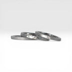 Three titanium stackable rings stacked together showing hammered, frosted, and diagonal textures, 2mm width, handcrafted in Utah