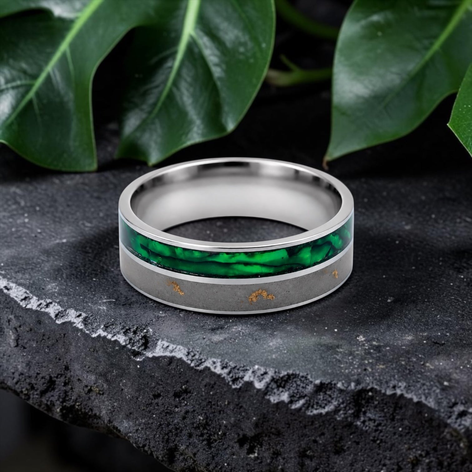 Close-up of titanium ring with paua shell inlay showing iridescent blue, green, and purple tones