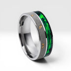 Close-up of titanium ring with paua shell inlay showing iridescent blue, green, and purple tones