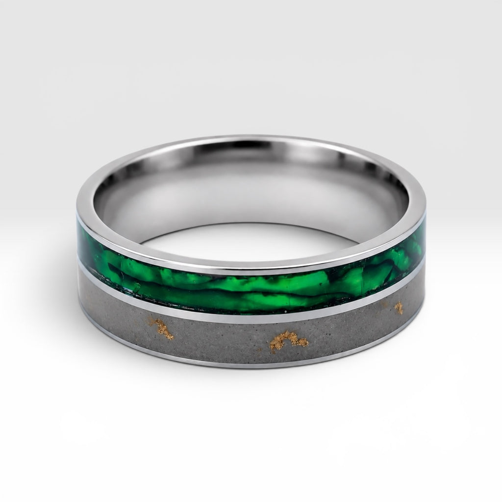 Close-up of titanium ring with paua shell inlay showing iridescent blue, green, and purple tones