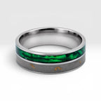 Close-up of titanium ring with paua shell inlay showing iridescent blue, green, and purple tones