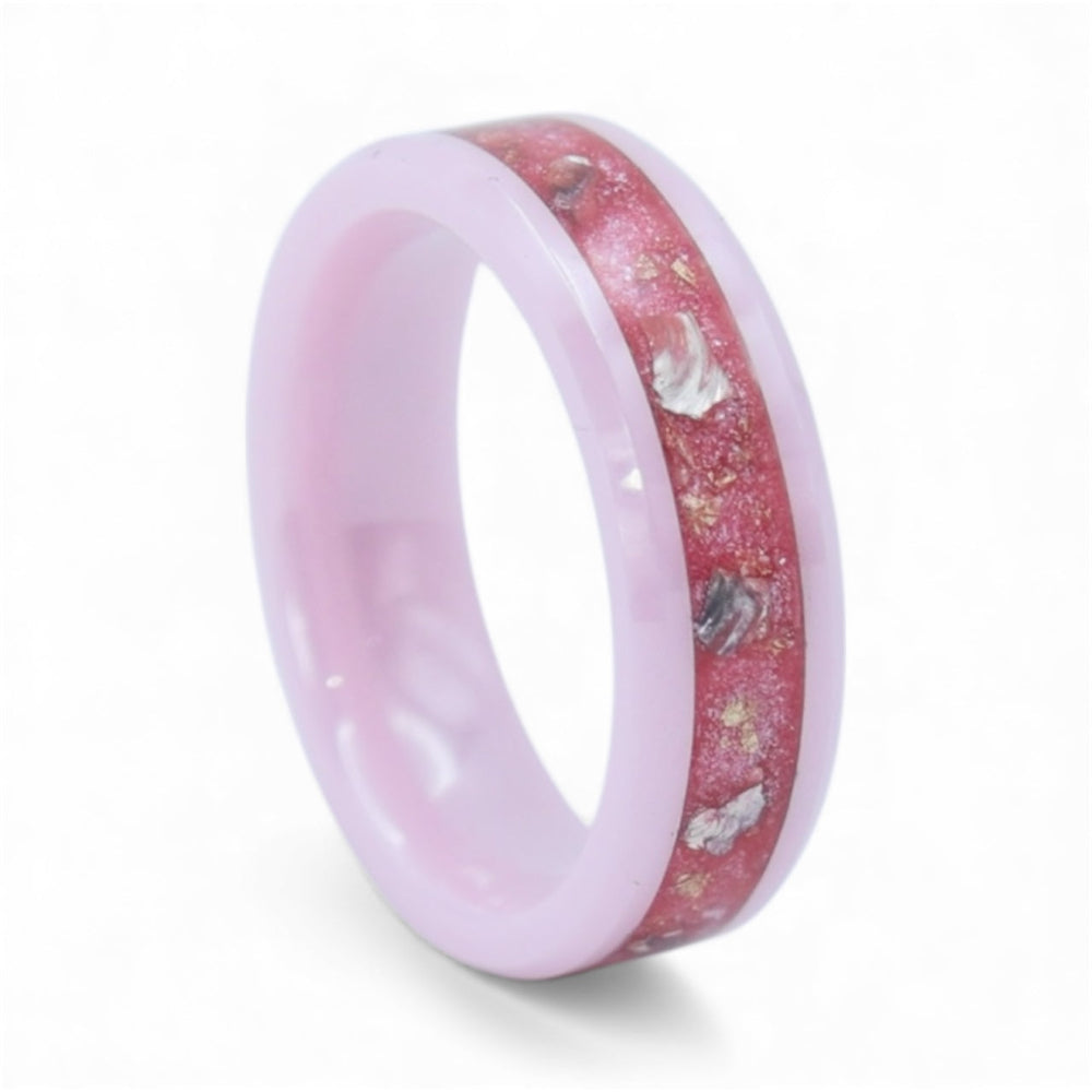 Close-up of pink ceramic ring with teal sea glass pieces and gold leaf set in resin inlay