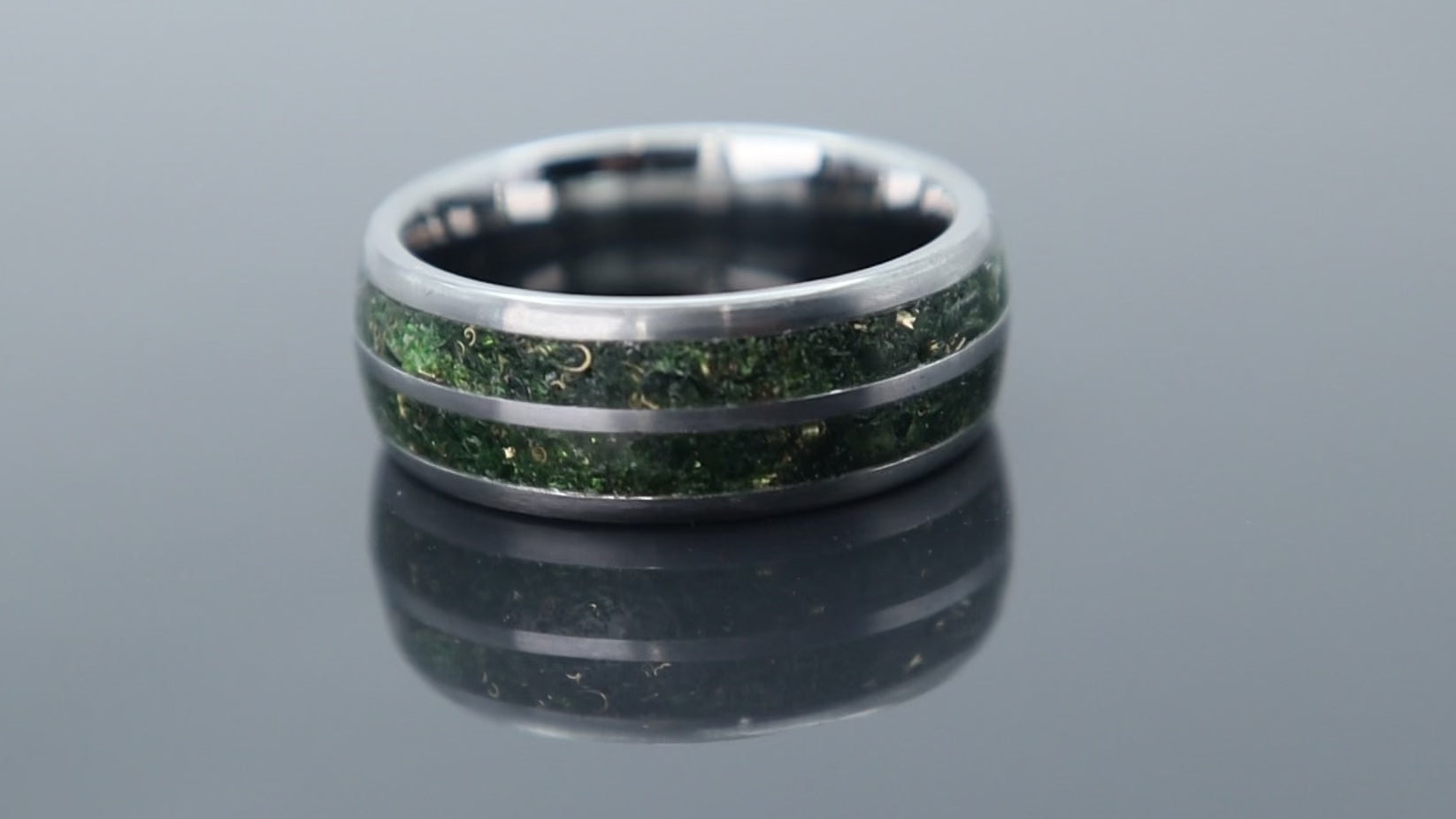 Handcrafted tungsten ring with green goldstone and gold accents, inspired by nature with a refined luxury finish