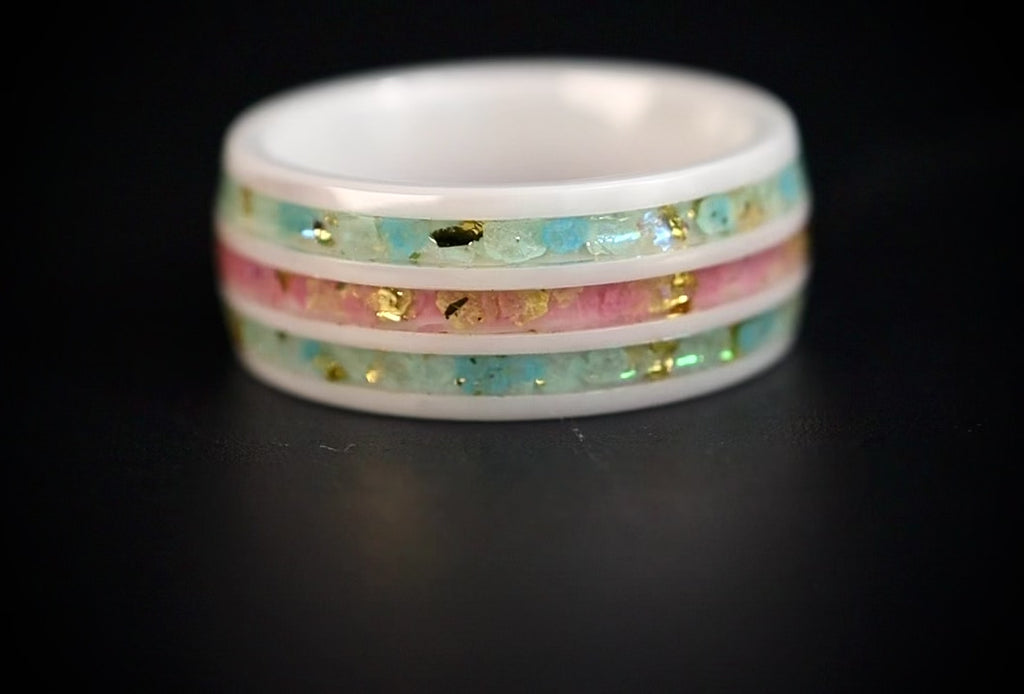 Bloomstripe white ceramic ring featuring three floral inlay channels with real flower petals, iridescent accents, and gold leaf details.