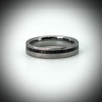 Faceted tungsten wedding ring with black tourmaline and 14k gold inlay in a 2mm offset channel