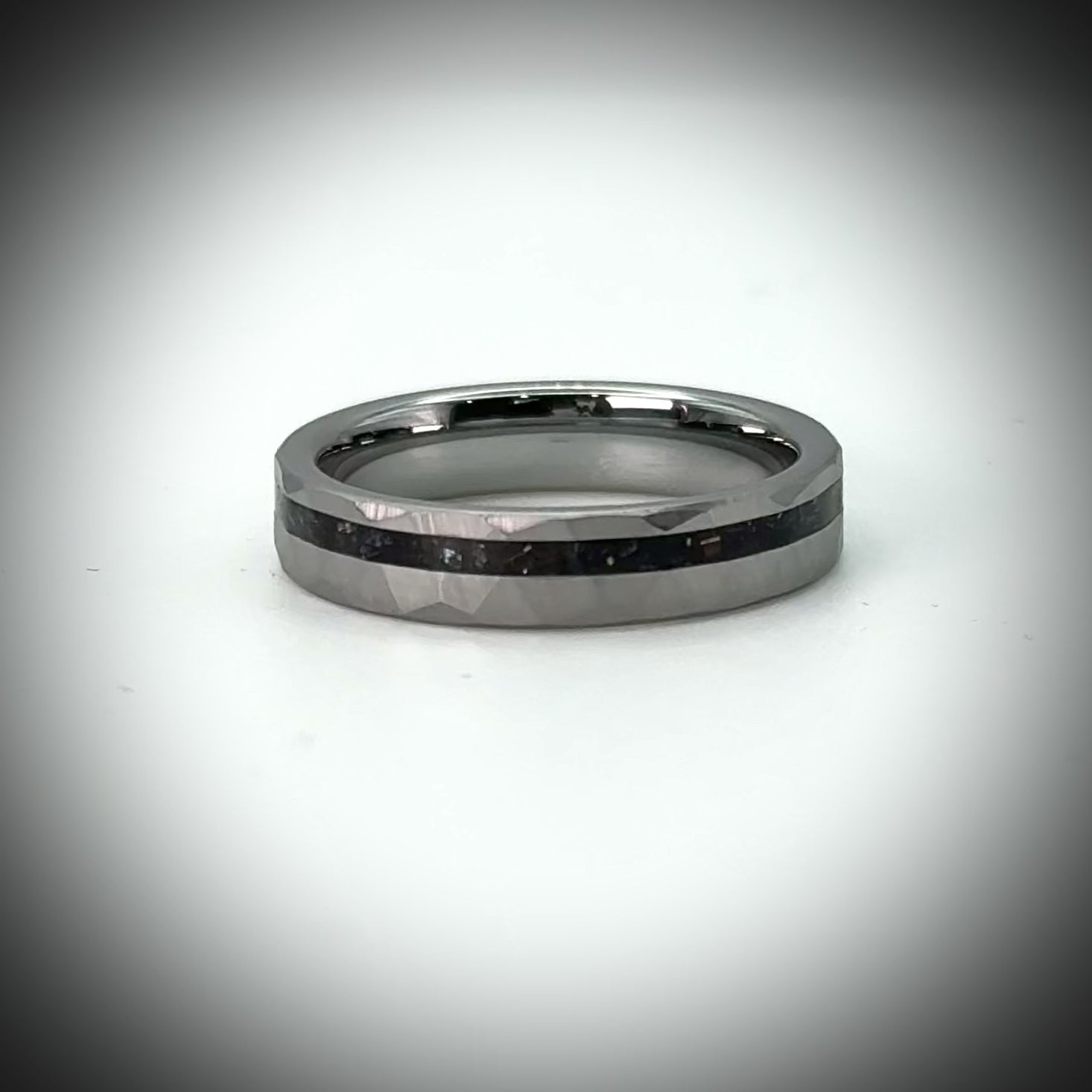 Faceted tungsten wedding ring with black tourmaline and 14k gold inlay in a 2mm offset channel