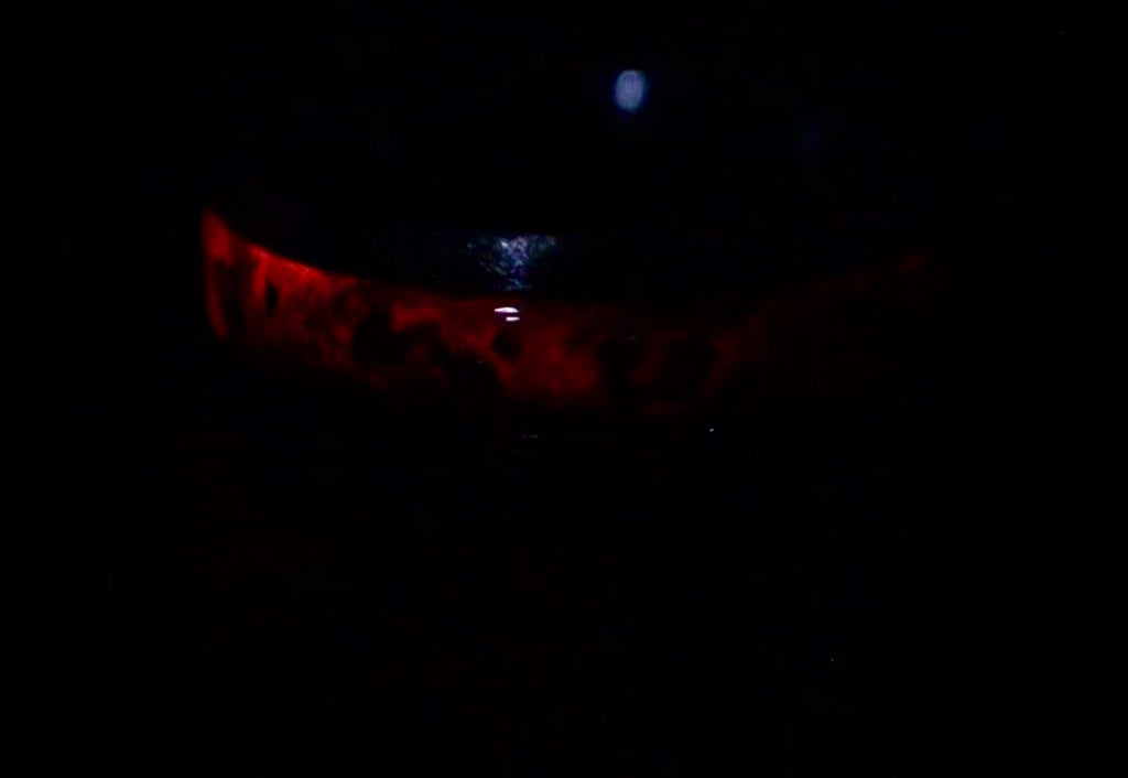 Cataclysm black titanium ring featuring meteorite fragments, blue dinosaur bone, lava stone inlay, and red glow accents with a rugged distressed finish.
