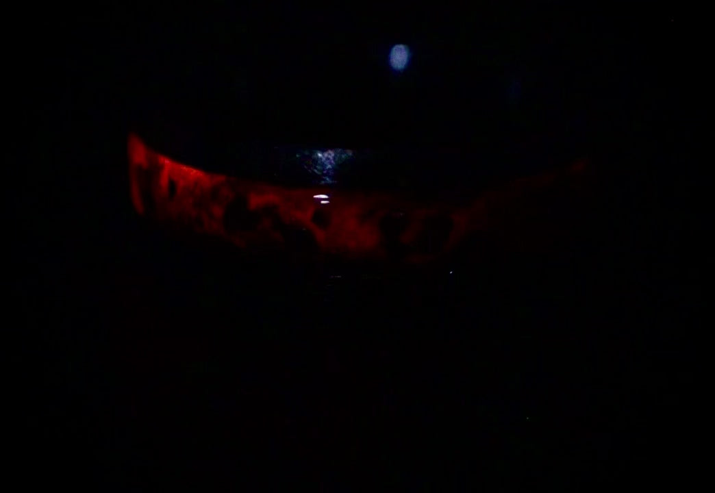 Cataclysm black titanium ring featuring meteorite fragments, blue dinosaur bone, lava stone inlay, and red glow accents with a rugged distressed finish.