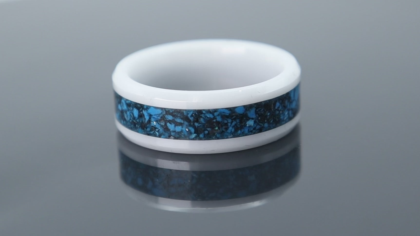 Ceramic ring with textured blue chrysocolla and silver leaf forming a wave-like pattern