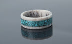 Rustic antler ring with smooth interior and turquoise inlay creating contrast between raw and refined