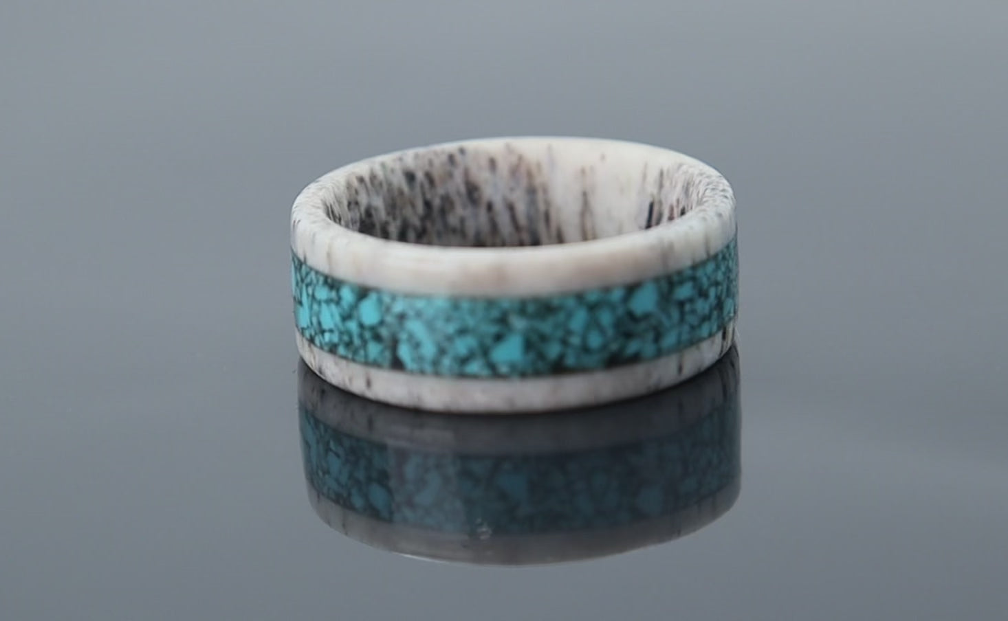 Rustic antler ring with smooth interior and turquoise inlay creating contrast between raw and refined