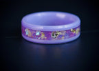 Fairybloom purple ceramic ring featuring real pressed flower petals, iridescent accents, and gold flakes preserved in a handcrafted floral inlay.