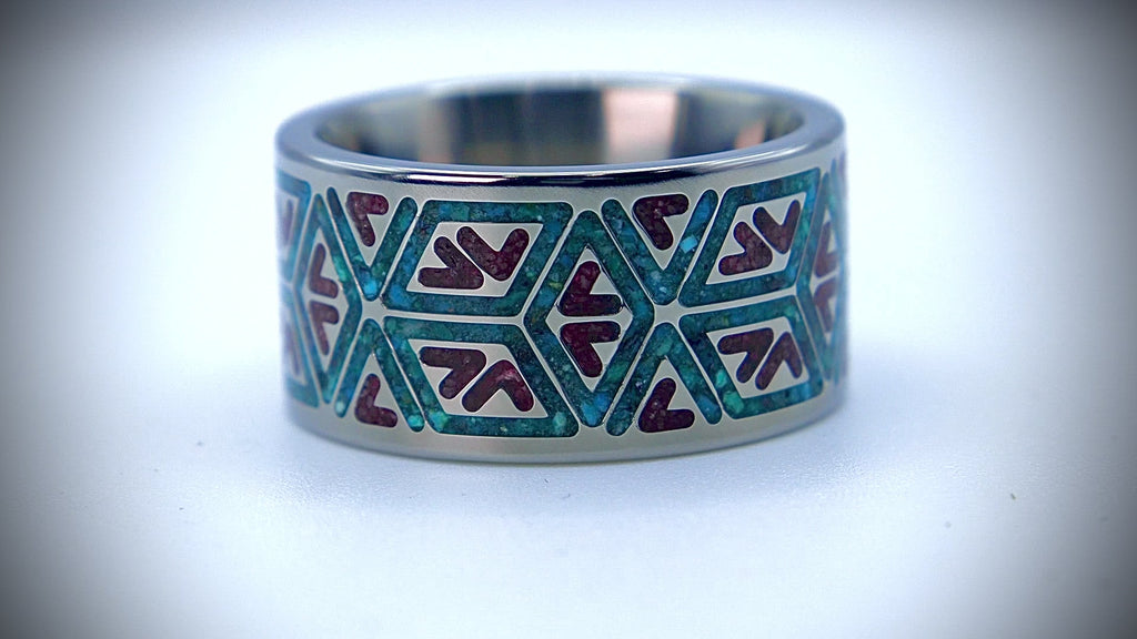 Handcrafted titanium ring featuring a tribal inlay of chrysocolla and cinnabar with bold turquoise and red contrast.