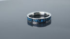 Close-up of titanium ring with chrysocolla inlay and silver leaf showing natural blue patterns and metallic texture