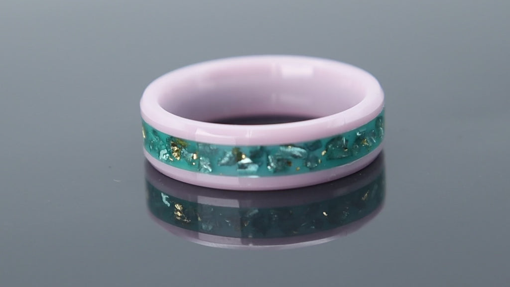 Ceramic ring with pink base, teal inlay and gold leaf reflecting sunset and ocean tones