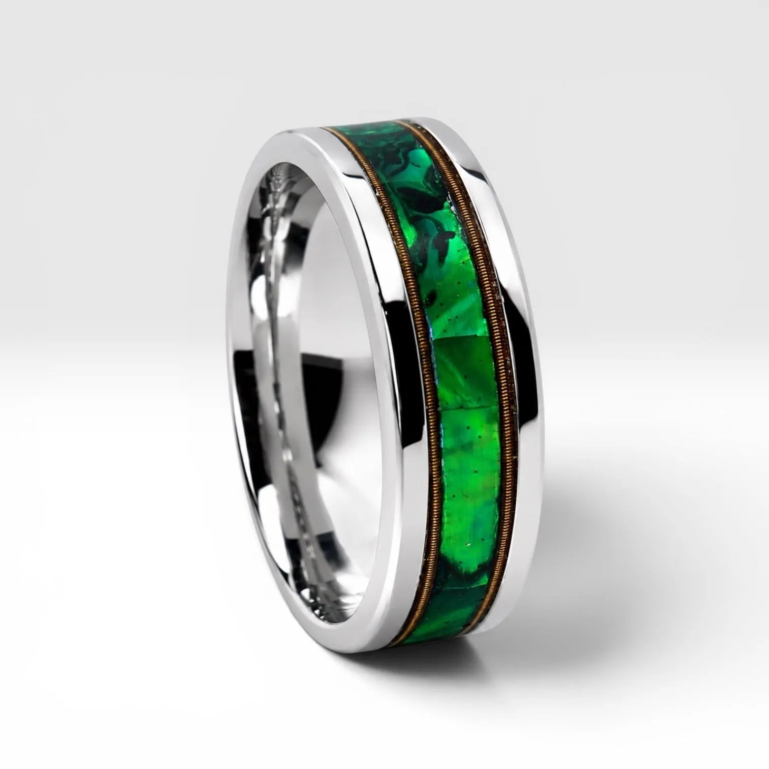 Polished titanium ring with paua abalone inlay and brass guitar strings, handcrafted for everyday wear