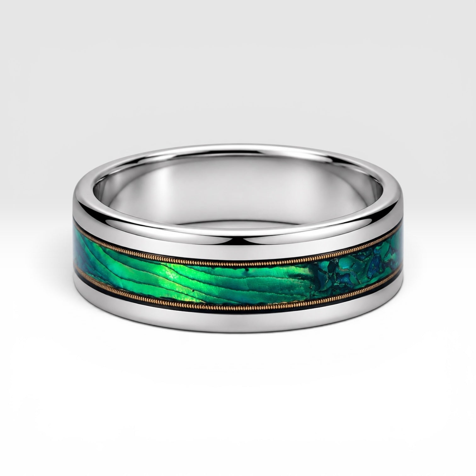 Polished titanium ring with paua abalone inlay and brass guitar strings, handcrafted for everyday wear