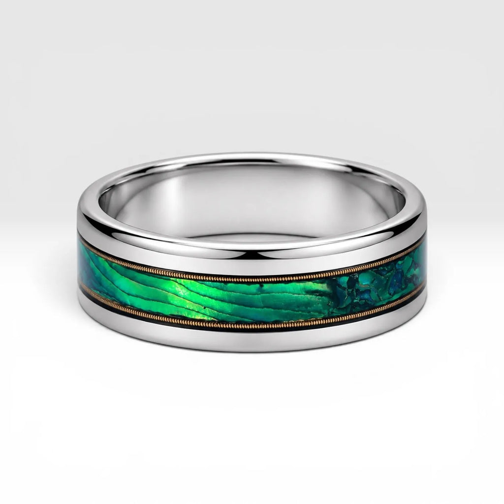 Polished titanium ring with paua abalone inlay and brass guitar strings, handcrafted for everyday wear