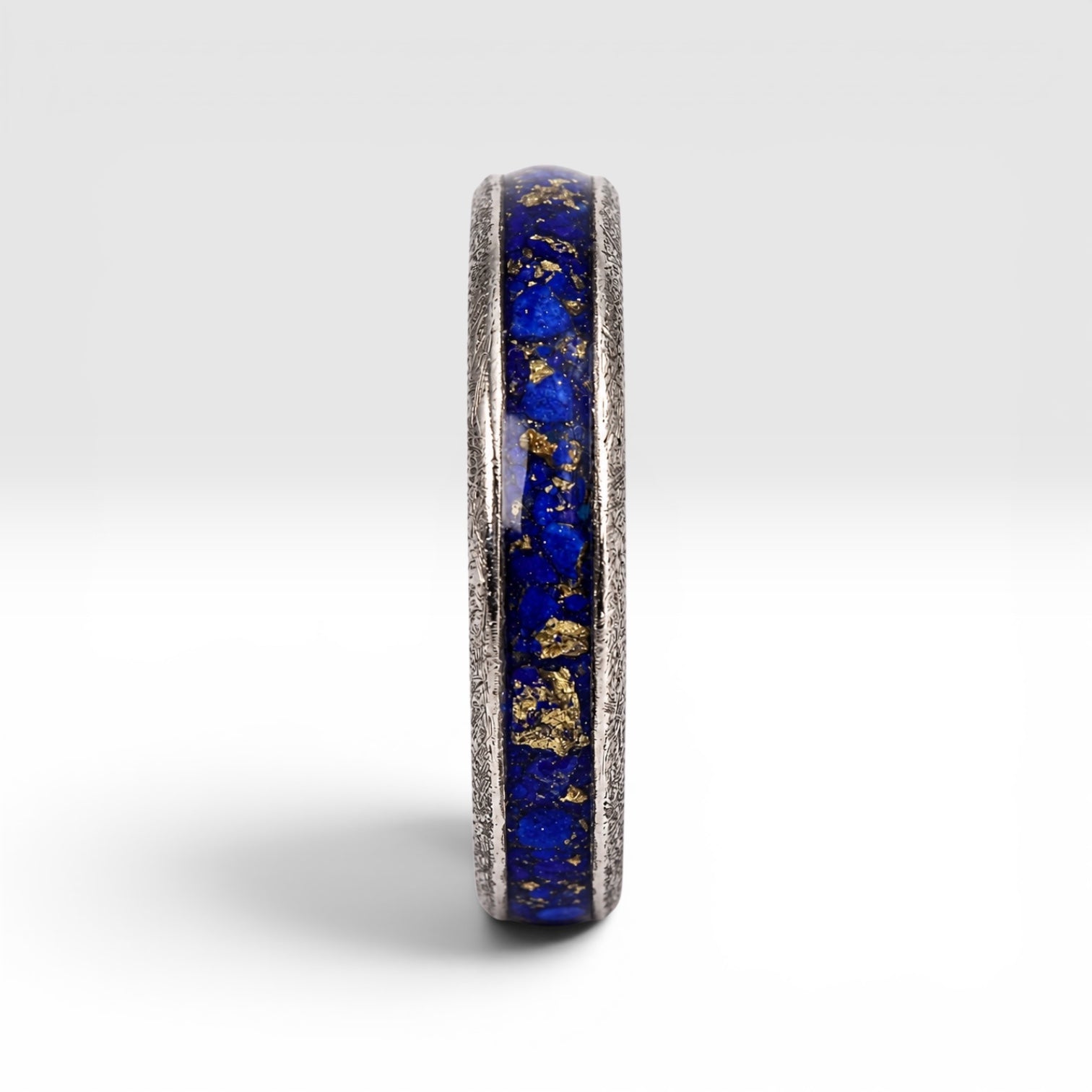 Regalis titanium ring featuring genuine lapis lazuli with natural bronze-colored inclusions and a distressed handcrafted finish.