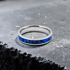 Close-up of titanium ring with chrysocolla inlay and silver leaf showing natural blue patterns and metallic texture