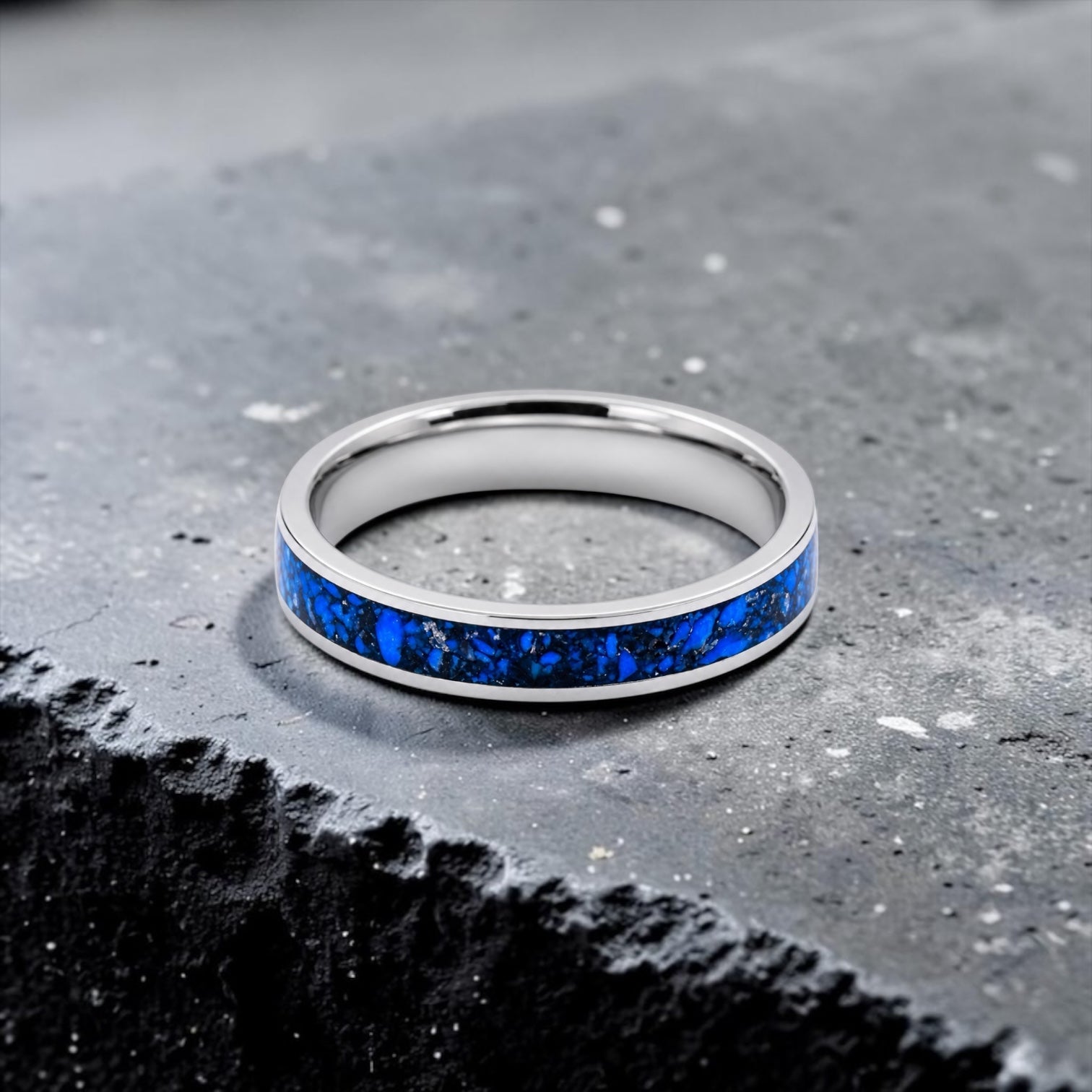 Close-up of titanium ring with chrysocolla inlay and silver leaf showing natural blue patterns and metallic texture