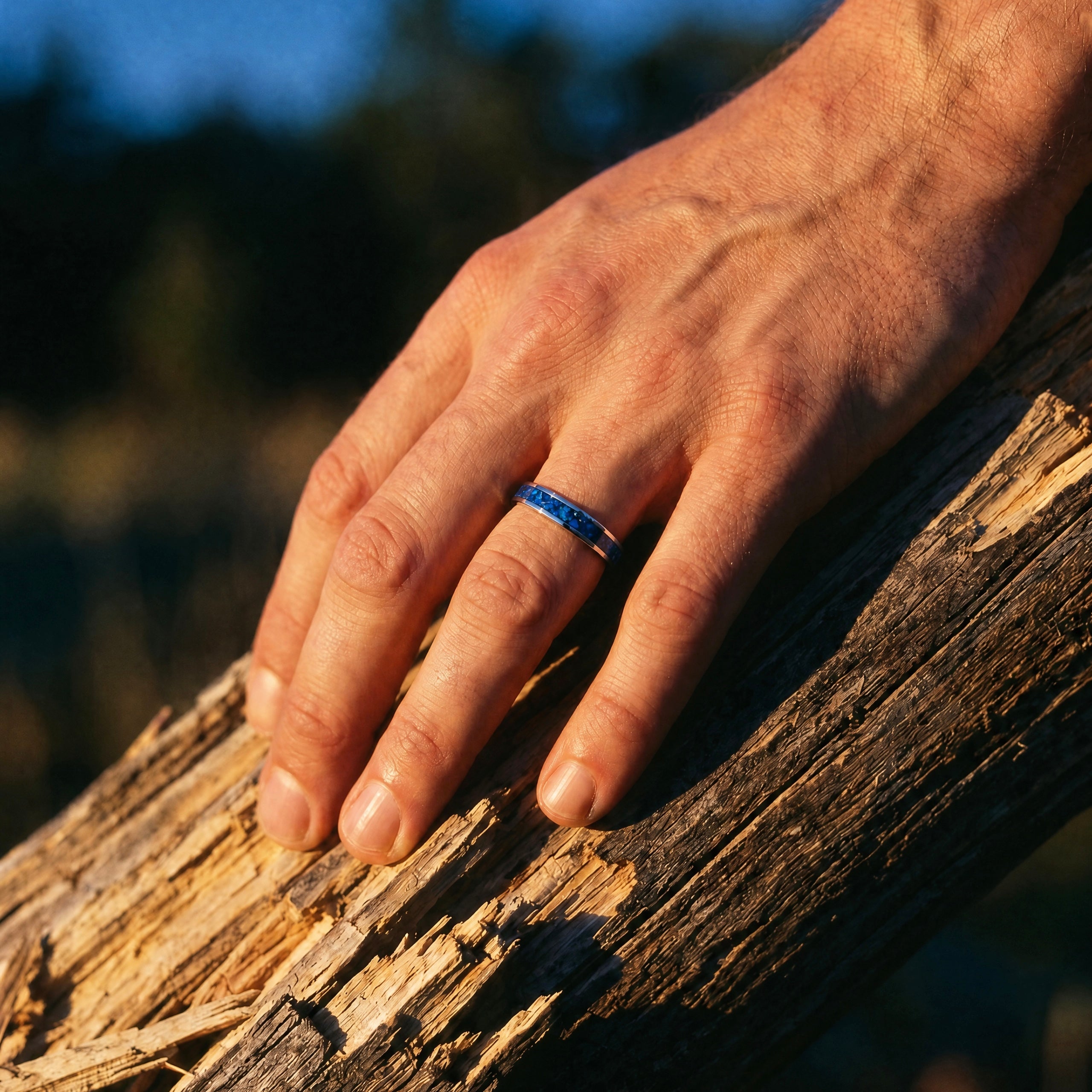 Close-up of titanium ring with chrysocolla inlay and silver leaf showing natural blue patterns and metallic texture