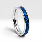 Close-up of titanium ring with chrysocolla inlay and silver leaf showing natural blue patterns and metallic texture