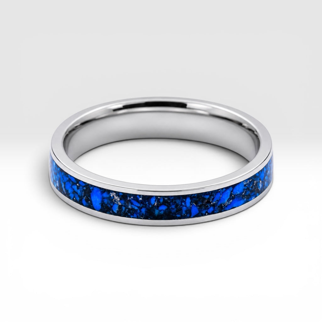 Close-up of titanium ring with chrysocolla inlay and silver leaf showing natural blue patterns and metallic texture