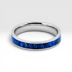 Close-up of titanium ring with chrysocolla inlay and silver leaf showing natural blue patterns and metallic texture