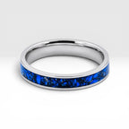 Close-up of titanium ring with chrysocolla inlay and silver leaf showing natural blue patterns and metallic texture