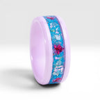 Skyblossom pink ceramic ring featuring preserved blue flower petals, pink pressed flowers, and iridescent accents in a handcrafted floral inlay.