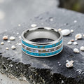 Close-up of tungsten ring with turquoise, mother of pearl and gold leaf showing layered ocean inspired inlay