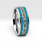 Close-up of tungsten ring with turquoise, mother of pearl and gold leaf showing layered ocean inspired inlay