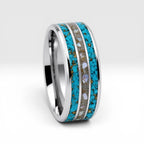 Close-up of tungsten ring with turquoise, mother of pearl and gold leaf showing layered ocean inspired inlay