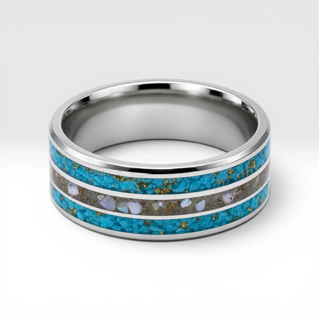 Close-up of tungsten ring with turquoise, mother of pearl and gold leaf showing layered ocean inspired inlay