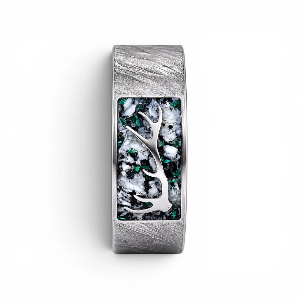Stagline titanium ring featuring genuine crushed elk tooth, natural malachite inlay, and an antler silhouette with a distressed handcrafted finish.