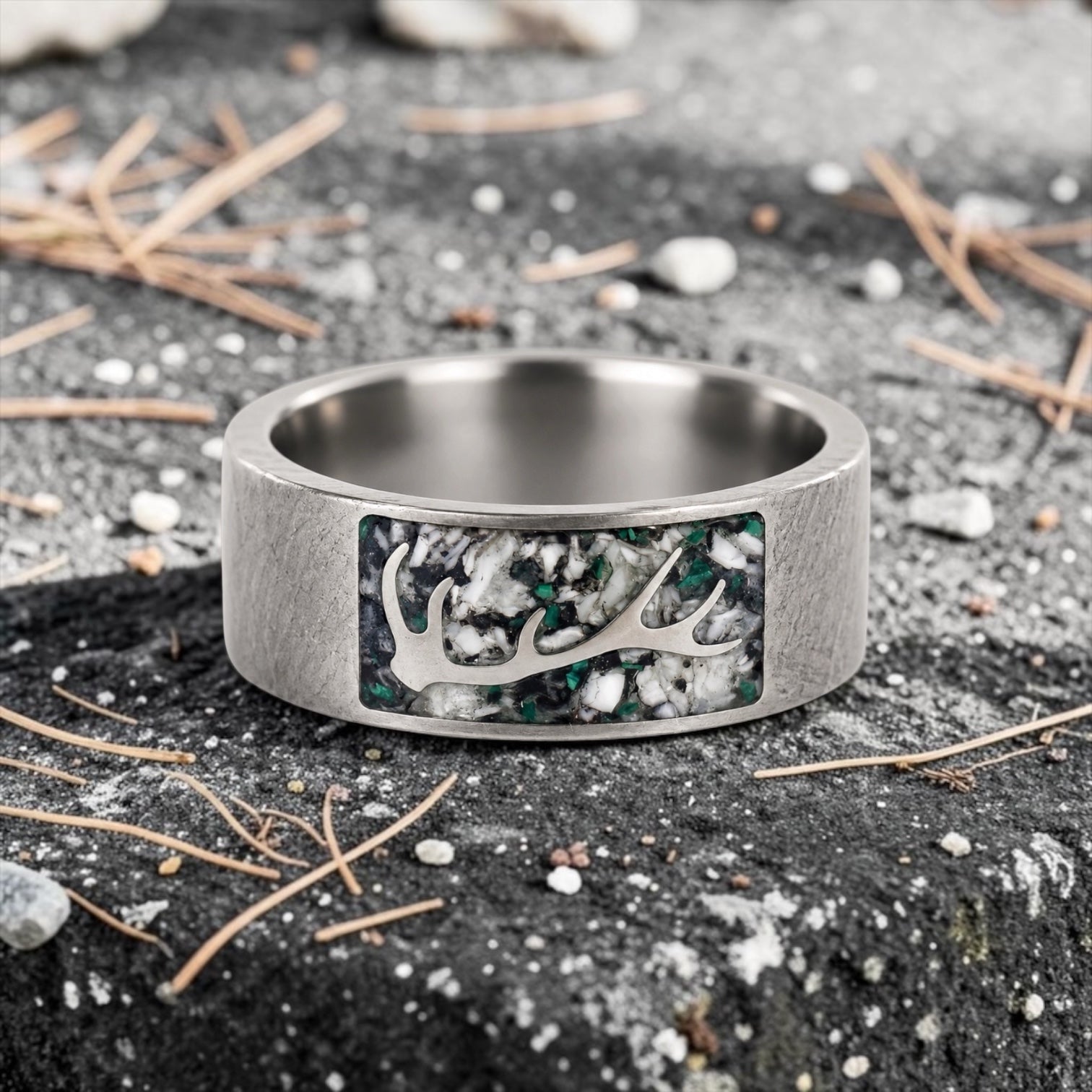 Stagline titanium ring featuring genuine crushed elk tooth, natural malachite inlay, and an antler silhouette with a distressed handcrafted finish.