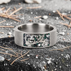 Stagline titanium ring featuring genuine crushed elk tooth, natural malachite inlay, and an antler silhouette with a distressed handcrafted finish.