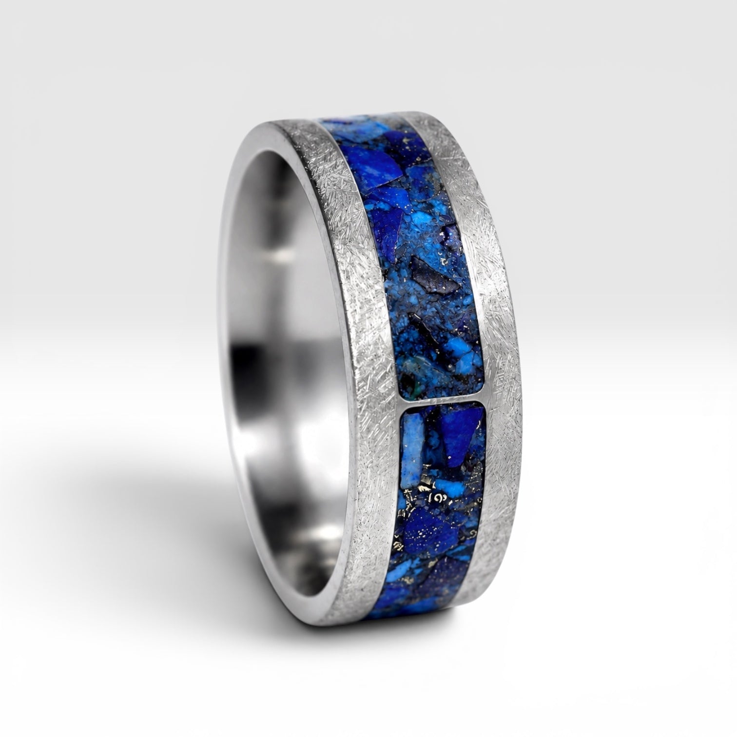 Stellaris titanium ring featuring a mosaic inlay of lapis lazuli, chrysocolla, turquoise, blue goldstone, and brass accents with a distressed finish.