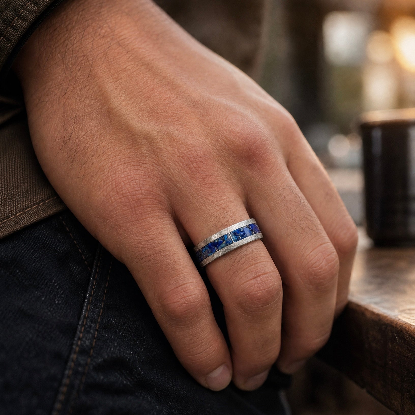 Stellaris titanium ring featuring a mosaic inlay of lapis lazuli, chrysocolla, turquoise, blue goldstone, and brass accents with a distressed finish.