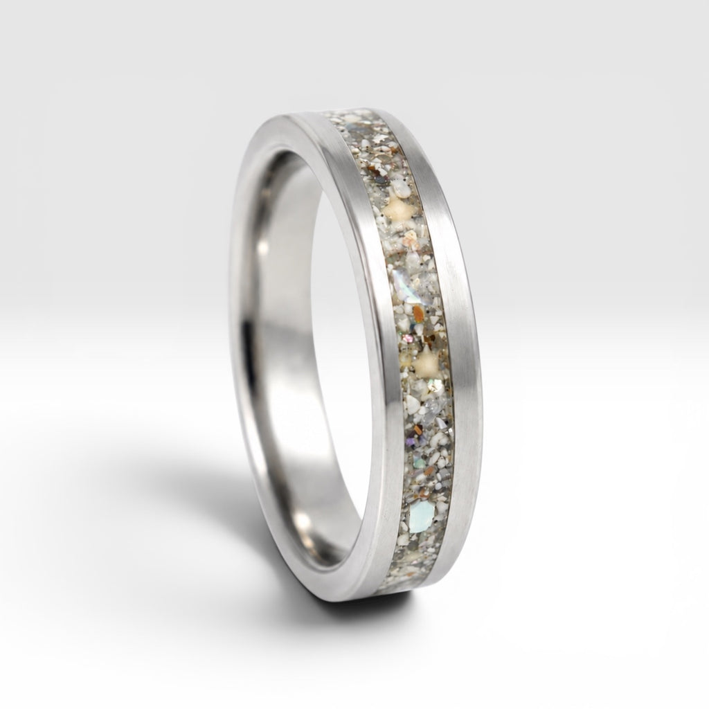 Stellatide titanium ring featuring Bermuda beach sand, Okinawa star sand, and mother of pearl inlay handcrafted by Venus Rings.