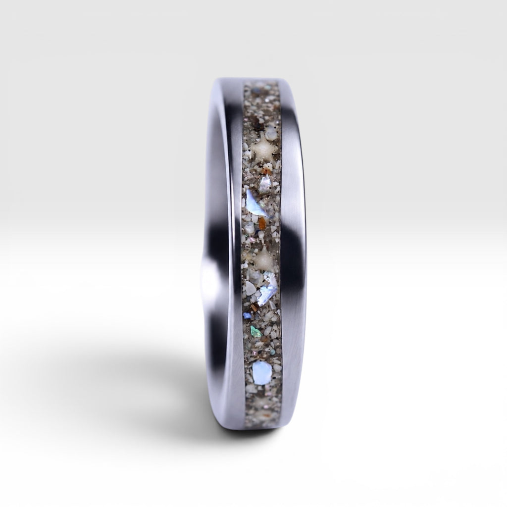 Stellatide titanium ring featuring Bermuda beach sand, Okinawa star sand, and mother of pearl inlay handcrafted by Venus Rings.