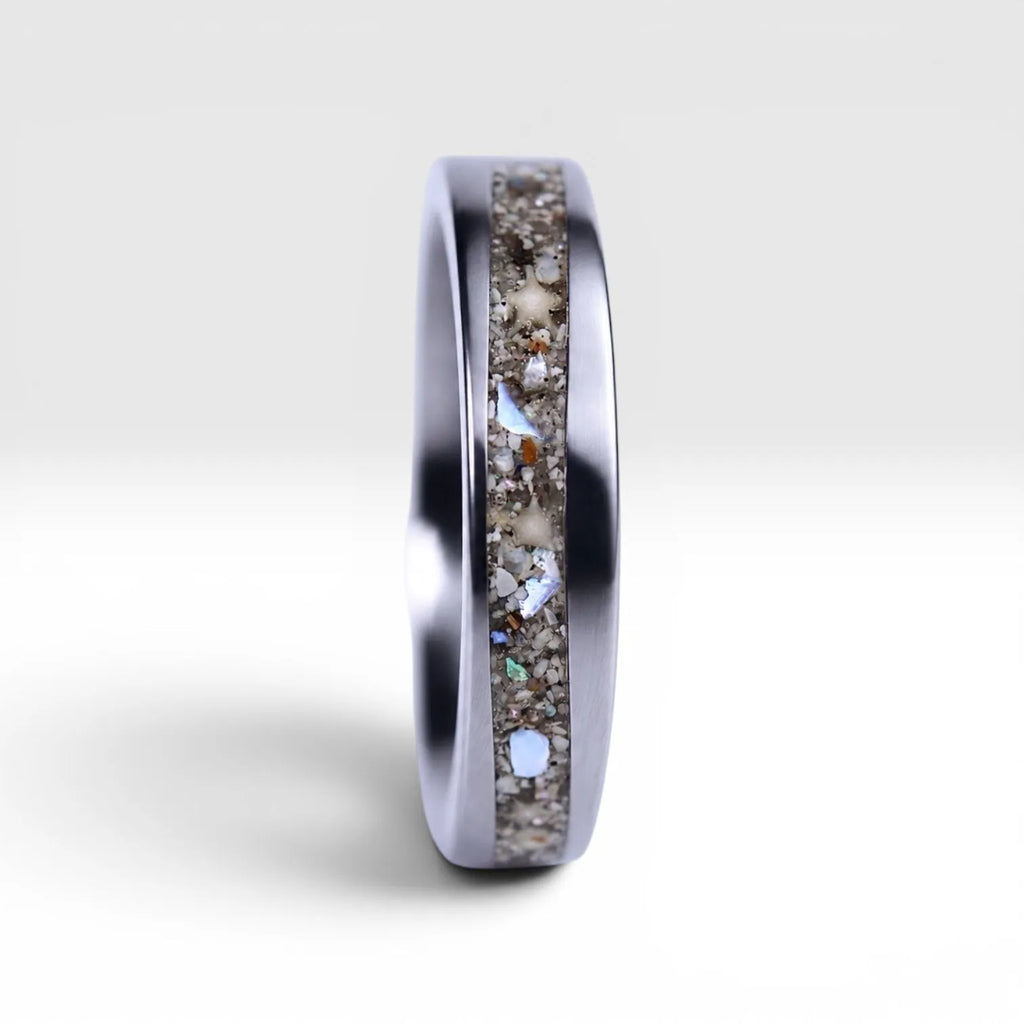 Stellatide titanium ring featuring Bermuda beach sand, Okinawa star sand, and mother of pearl inlay handcrafted by Venus Rings.