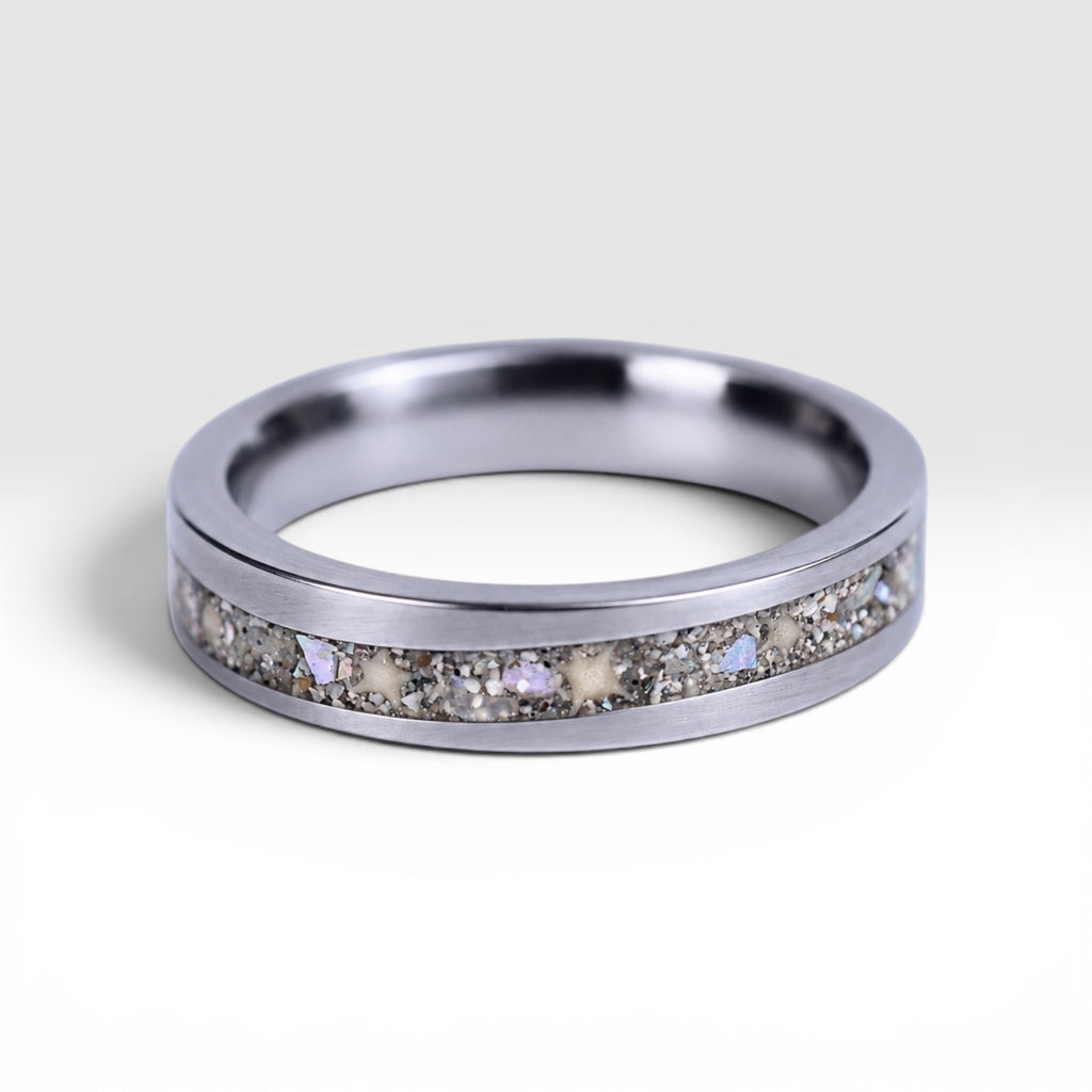 Stellatide titanium ring featuring Bermuda beach sand, Okinawa star sand, and mother of pearl inlay handcrafted by Venus Rings.