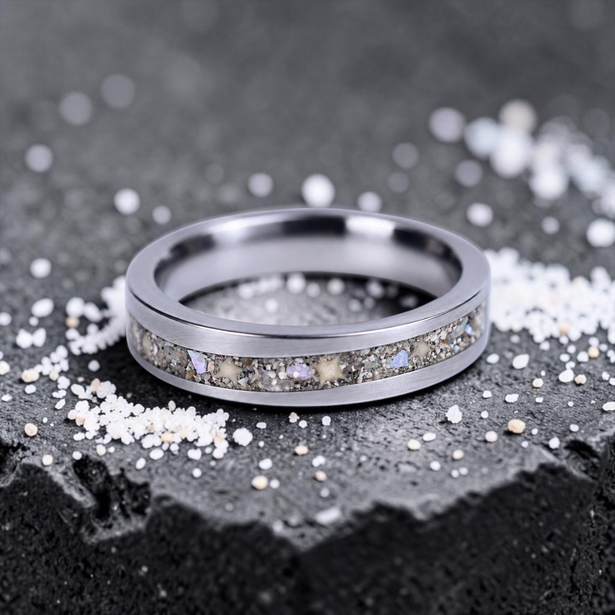 Stellatide titanium ring featuring Bermuda beach sand, Okinawa star sand, and mother of pearl inlay handcrafted by Venus Rings.