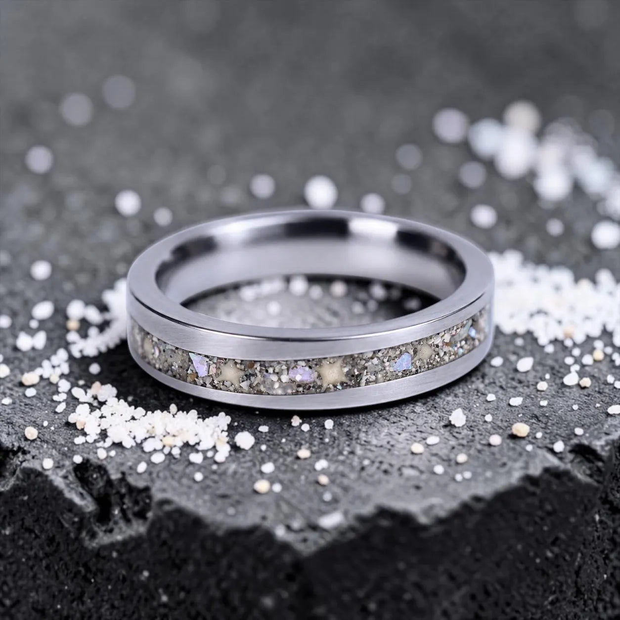 Stellatide titanium ring featuring Bermuda beach sand, Okinawa star sand, and mother of pearl inlay handcrafted by Venus Rings.