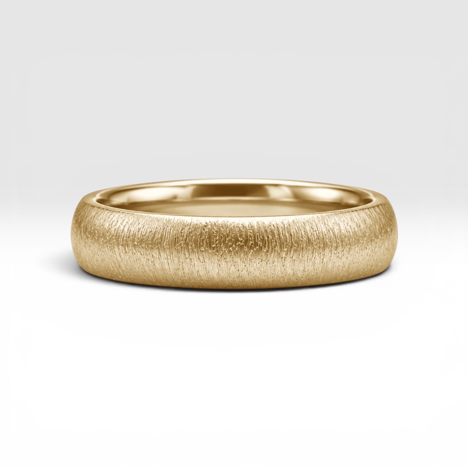 4mm domed gold women's wedding band with fine vertical texture creating a luminous sparkle effect
