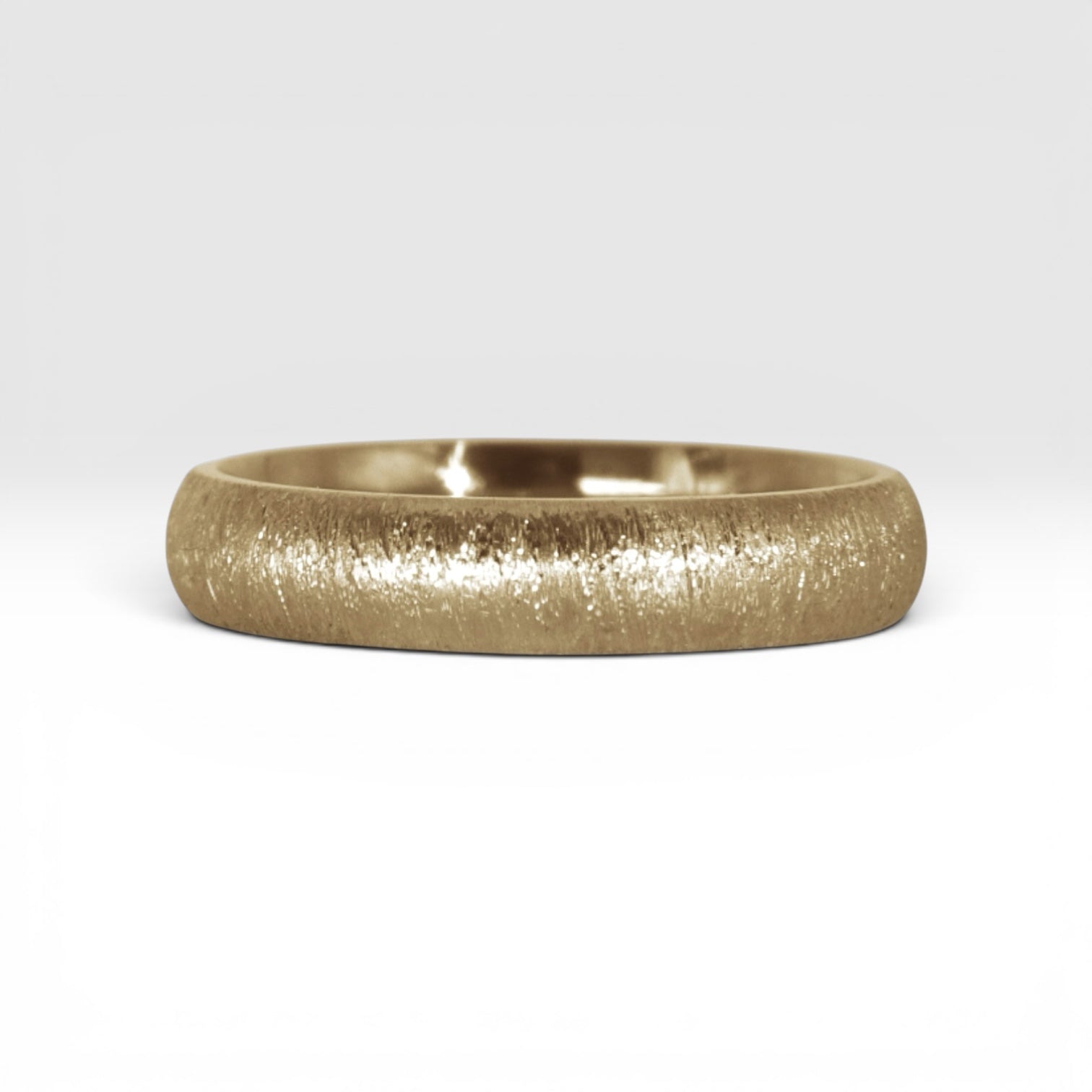 4mm domed gold women's wedding band with fine vertical texture creating a luminous sparkle effect