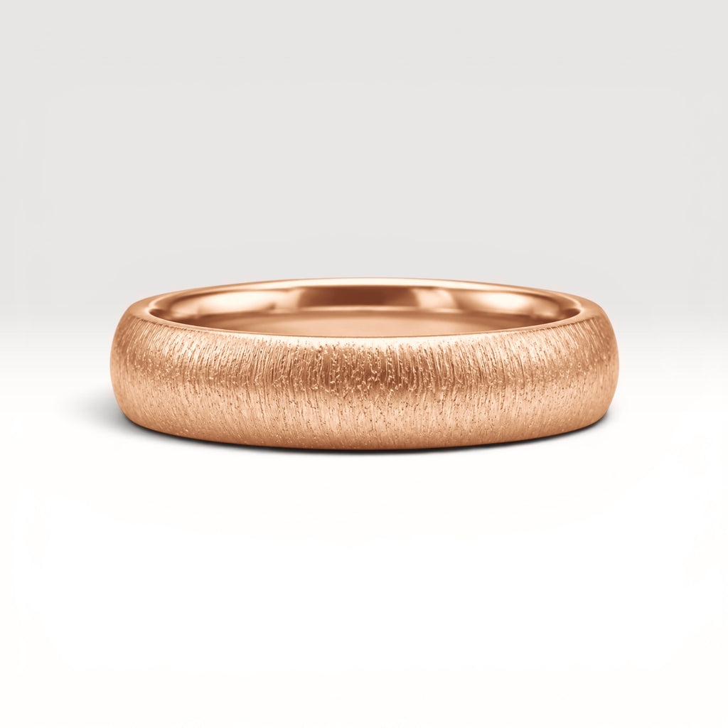 4mm domed rose gold women's wedding band with fine vertical texture creating a luminous sparkle effect